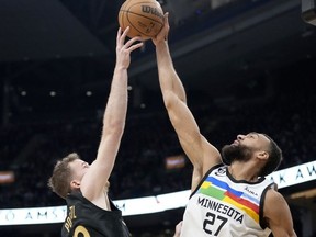 Le centre des Timberwolves du Minnesota Rudy Gobert (27 ans) bloque un tir du centre des Raptors de Toronto Jakob Poeltl (19 ans) lors de la première mi-temps de l'action de basket-ball de la NBA à Toronto, le samedi 18 mars 2023.