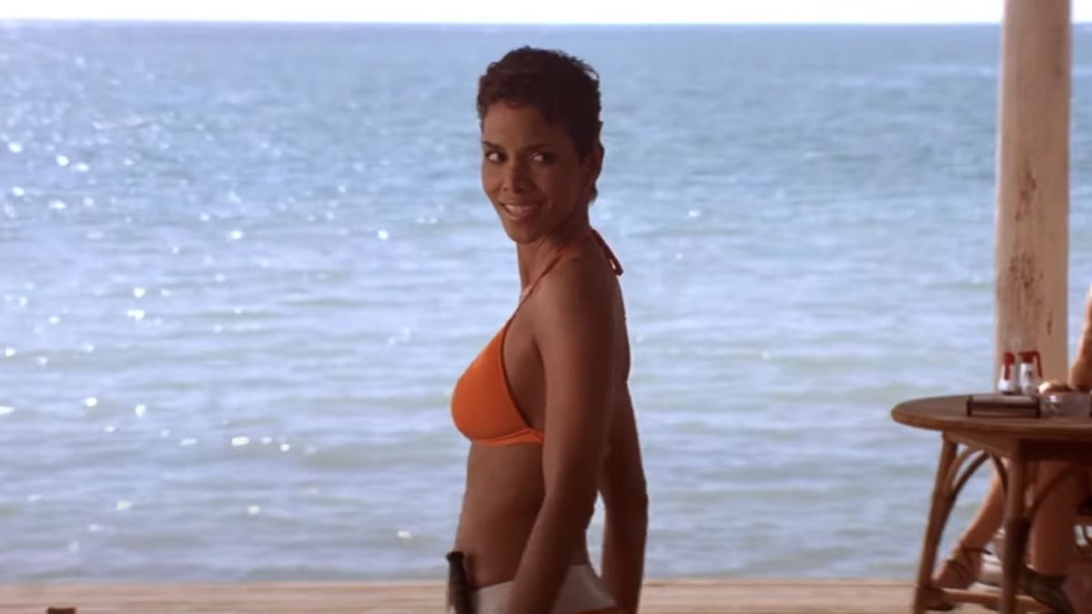 Halle Berry looks over her shoulder in an orange bikini in Die Another Day.