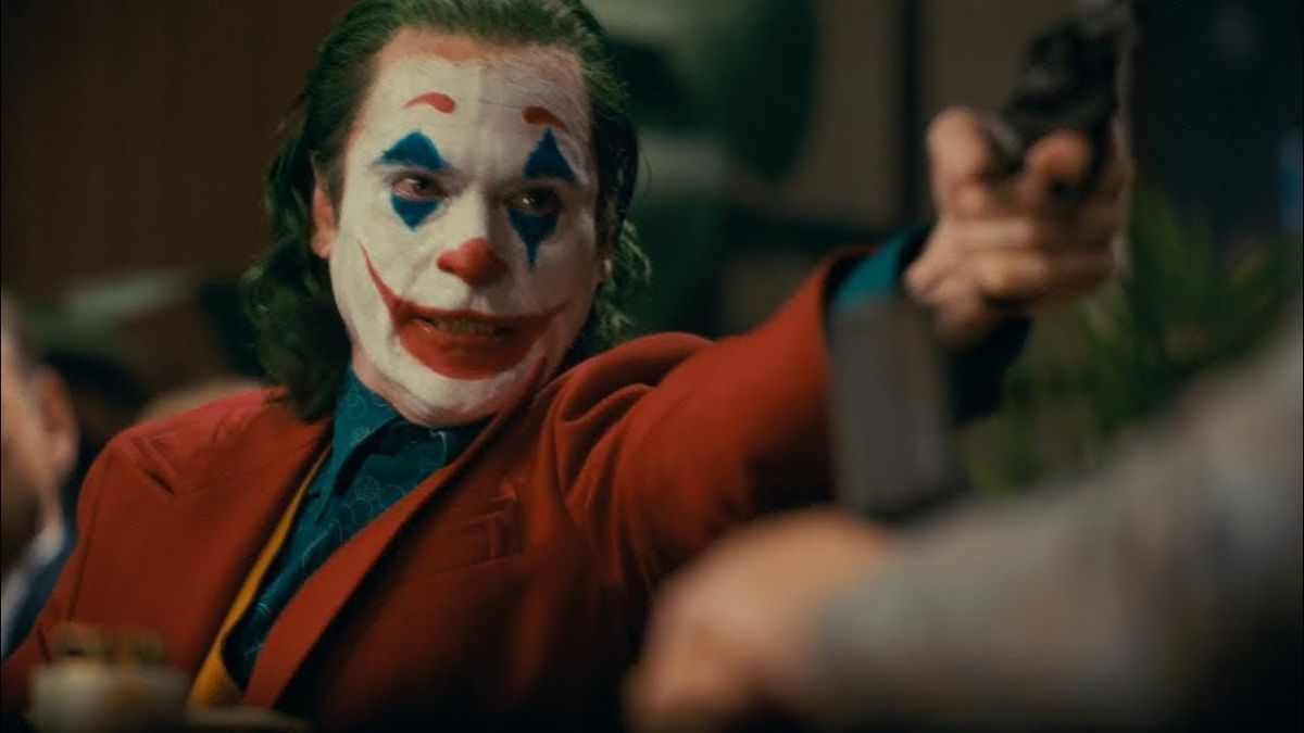 Joaquin Phoenix as Joker with a gun