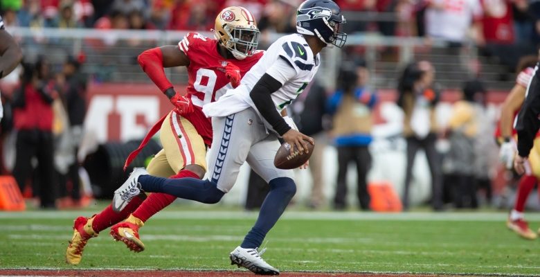 SANTA CLARA, CA - JANUARY 14: Geno Smith #7 of the Seattle Seahawks looks for a receiver against the San Francisco 49ers during the NFC Wild Card playoff game at Levi's Stadium on January 14, 2023 in Santa Clara, California. The 49ers defeated the Seahawks 41-23. (Photo by Michael Zagaris/San Francisco 49ers/Getty Images)