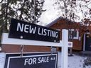 Un panneau immobilier « à vendre » à l'extérieur d'une maison de banlieue à Calgary.