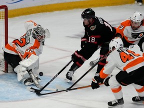 Le gardien des Flyers Felix Sandstrom effectue un arrêt sur le centre des Sénateurs Tim Stutzle alors que les défenseurs Cam York et Ivan Provorov défendent au cours de la première période du match de jeudi.