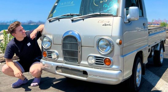 Ludwig Ahgren poses beside his dream car, a Subaru Sambar microvan.