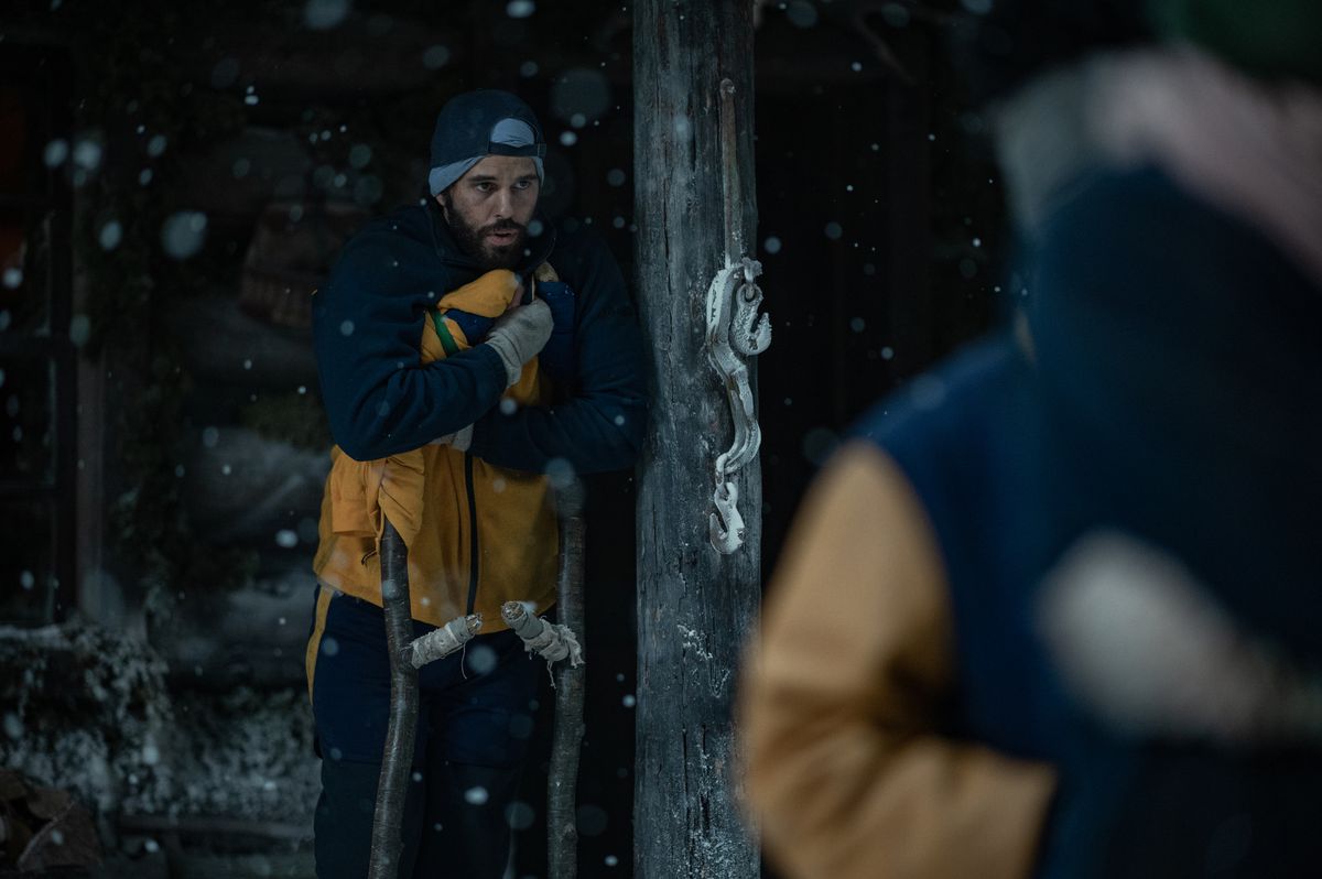 L'entraîneur Ben (Steven Krueger) debout et l'air froid appuyé contre un poteau dans une photo de la saison 2 des Yellowjackets