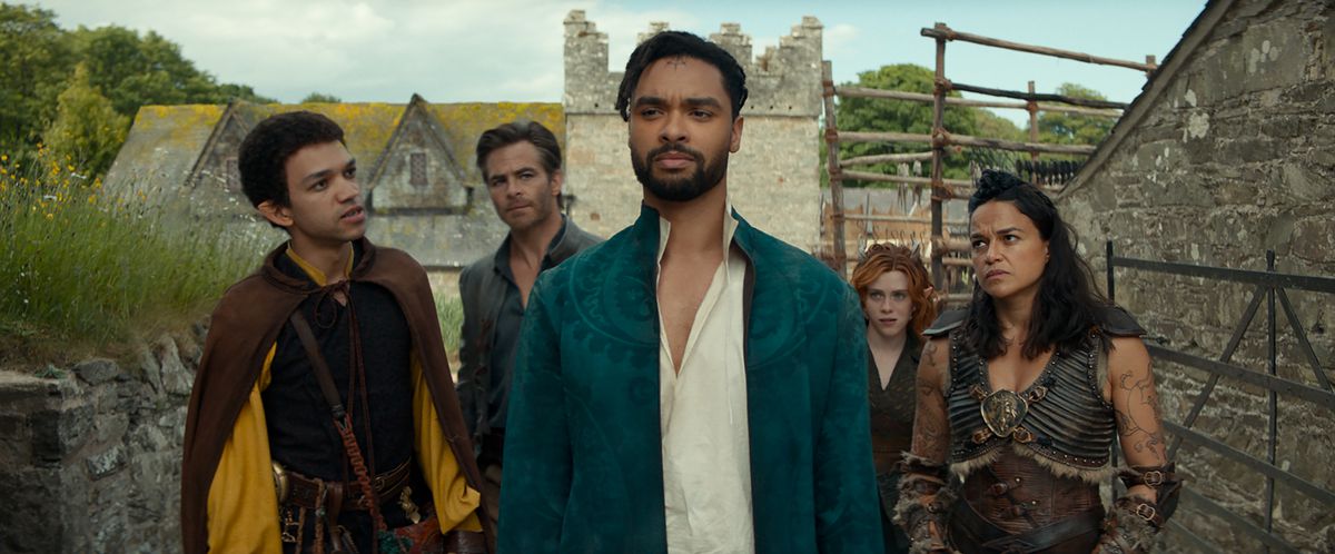 LtR : Justice Smith joue Simon, Chris Pine joue Edgin, Rege-Jean Page joue Xenk, Sophia Lillis joue Doric et Michelle Rodriguez joue Holga dans Dungeons &AMP ;  Dragons : Honneur parmi les voleurs.  Tous les autres personnages regardent Xenk avec scepticisme, alors qu'il semble inconscient.