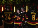 Quinn Hughes (au centre) des Canucks de Vancouver s'adresse aux fans après avoir battu les Flames de Calgary lors de leur dernier match de hockey à domicile de l'année dans la LNH le 8 avril 2023.