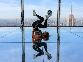 Lia Lewis, une compétitrice anglaise de football freestyle, jongle avec un ballon de football lors d'un événement de dévoilement du trophée de la Coupe du monde féminine à New York vendredi.  Angela Weiss/AFP