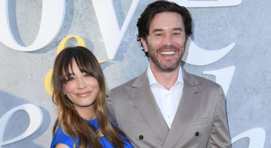 Kaley Cuoco and Tom Pelphrey standing together smiling at Love and Death premiere