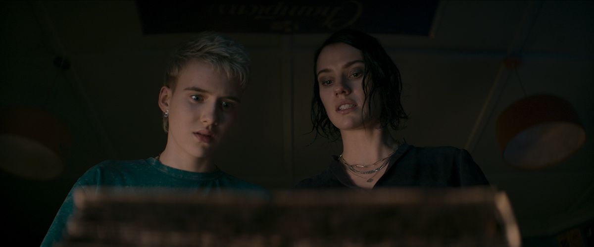 Le DJ adolescent Danny (Morgan Davies) et sa tante Beth (Lily Sullivan) regardent avec horreur le Livre des morts dans Evil Dead Rise