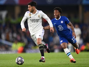 Marco Asensio du Real Madrid court avec le ballon sous la pression de Raheem Sterling de Chelsea lors du match retour du quart de finale de l'UEFA Champions League entre le Chelsea FC et le Real Madrid à Stamford Bridge le 18 avril 2023 à Londres.