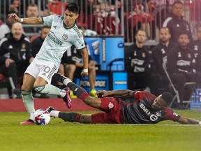 Le milieu de terrain d'Atlanta United Luiz Araujo (10) joue le ballon contre le milieu de terrain du Toronto FC Mark-Anthony Kaye (14) lors de la première mi-temps de l'action MLS Soccer à Toronto, le samedi 15 avril 2023.