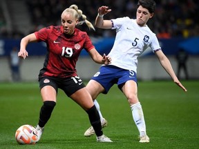 La défenseuse française Elisa De Almeida (à droite) se bat pour le ballon avec l'attaquante canadienne Adriana Leon (à gauche) lors du match de football international amical féminin entre la France et le Canada au stade Marie Marvingt, au Mans, dans le nord-ouest de la France, le 11 avril 2023.