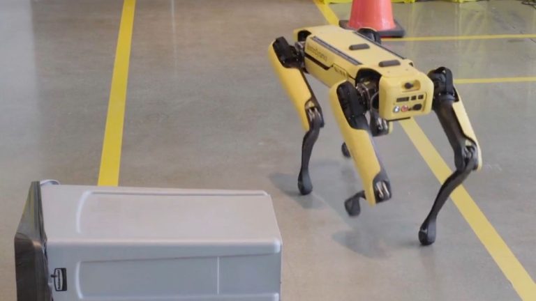 Spot the robot dog moves around a fallen bin.