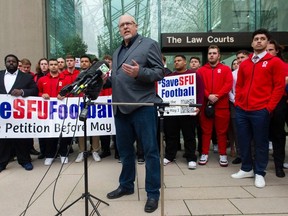 Jim Mullin, président de Football Canada, se joint aux joueurs actuels et passés du programme de football de la SFU à la Cour suprême de la Colombie-Britannique à Vancouver le 13 avril.