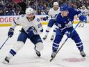 Le défenseur du Lightning Ian Cole (28 ans) va vérifier l'attaquant des Maple Leafs Mitch Marner (16 ans) lors de la première période du premier match de la première ronde des séries éliminatoires de la Coupe Stanley à la Scotiabank Arena de Toronto, le mardi 18 avril 2023.