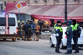 Des enquêteurs de la police russe inspectent un café de rue endommagé lors d'une explosion à Saint-Pétersbourg le 2 avril 2023.