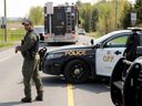 La police bloque le secteur devant une maison de la rue Laval à Bourget, Ont., le 11 mai 2023.