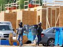 Photo d'archive : Des ouvriers du bâtiment travaillent sur de nouvelles maisons à Ottawa, Ontario, Canada, le 27 mai 2021.  