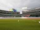 L'équipe de terrain commence à retirer la bâche du champ intérieur pour préparer le terrain pour le jeu après un retard de pluie avant le match entre les Mariners de Seattle et Oakland Athletics au RingCentral Coliseum le 3 mai 2023 à Oakland, en Californie.