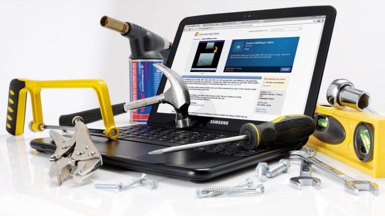 A laptop covered in tools and equipment