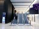 Les gens utilisent un escalator dans le hall principal de l'immeuble de bureaux Brookfield Place Sydney, propriété et siège du siège social Asie-Pacifique de Brookfields Asset Management Inc., à Sydney, en Australie.