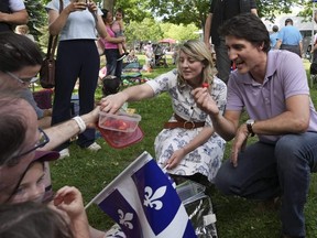 Le premier ministre Justin Trudeau, à droite, et la ministre des Affaires étrangères Mélanie Joly accueillent les familles lors d'un événement de la Fête nationale du Québec le vendredi 23 juin 2023 à Montréal.