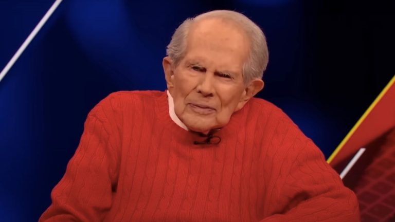 Pat Robertson in a red sweater, during a broadcast of The 700 Club.