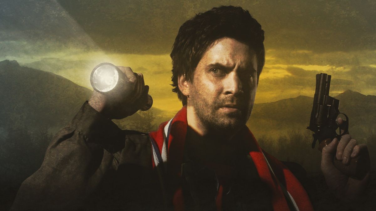 Alan Wake raises his flashlight in one hand, with his pistol in the other, among a backdrop of foggy mountains.