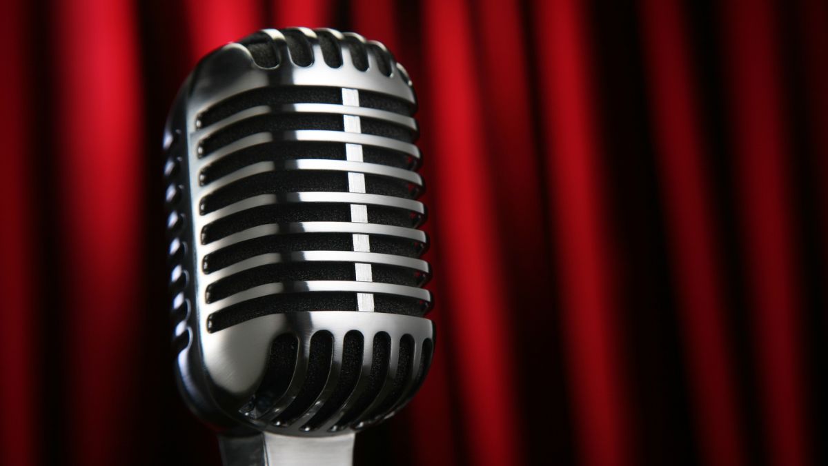 A microphone set against a red background.