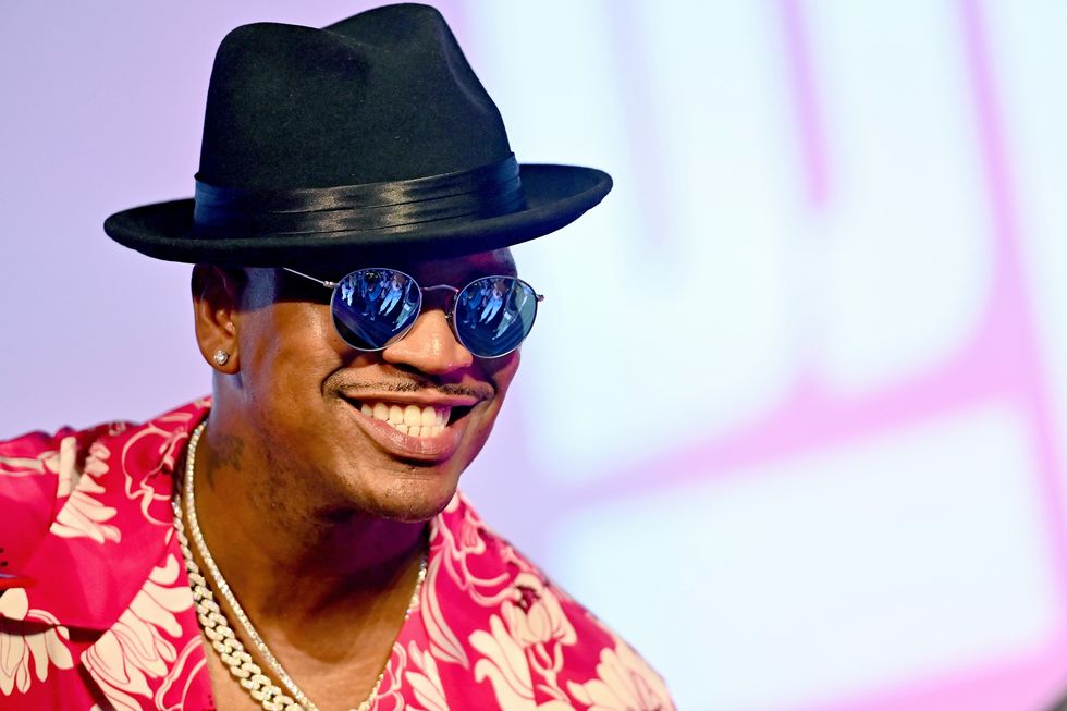 neyo en lunettes de soleil et un har souriant