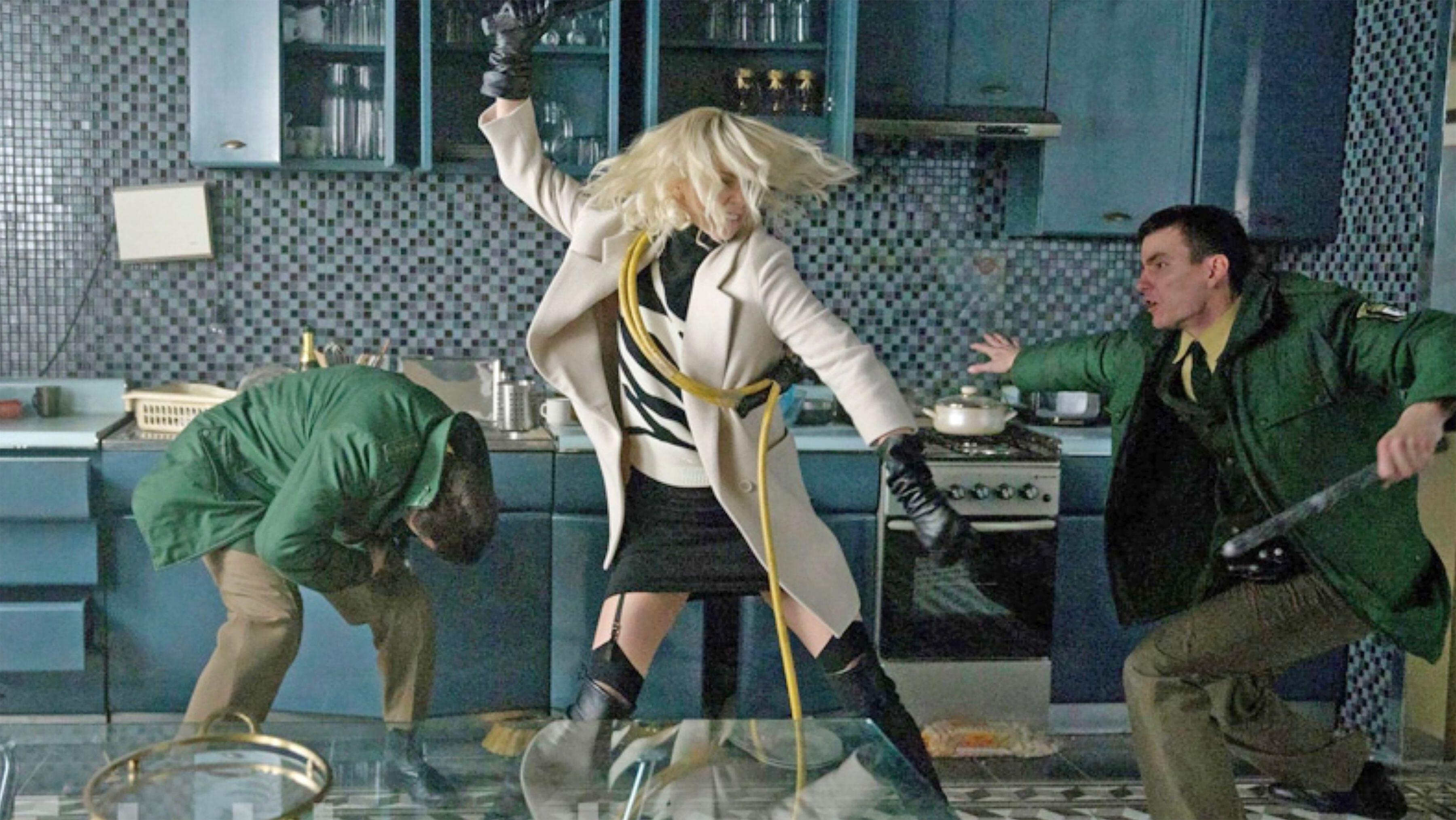 Charlize Theron dans le rôle de Lorraine Broughton combattant des hommes devant et derrière elle dans Atomic Blonde