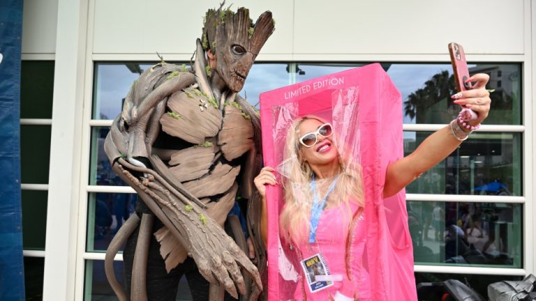 Cosplayers dressed as Groot and Barbie take a selfie at the 2023 Comic-Con International: San Diego at the San Diego Convention Center on July 22, 2023 in San Diego, California.