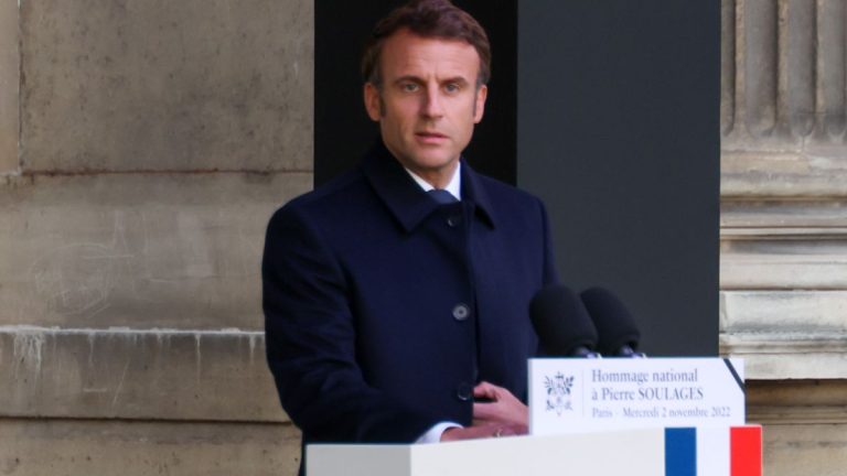 Emmanuel Macron addressing people from a lectern.