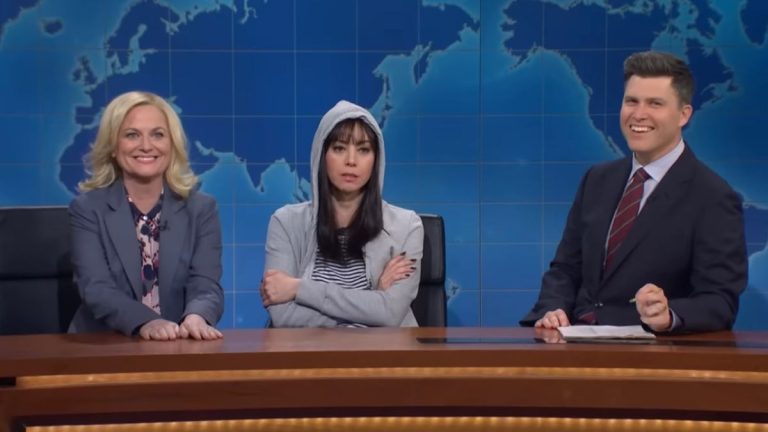 Amy Poehler as Leslie Knope and Aubrey Plaza as April Ludgate on Weekend Update with Colin Jost on SNL.