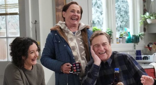 Jackie, Darlene and Dan smiling at table in The Conners