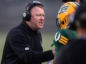 L'entraîneur-chef des Elks d'Edmonton, Chris Jones, parle à un joueur alors qu'il affronte les Tiger-Cats de Hamilton.