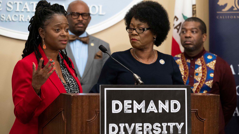 (From left) Senator Lola Smallwood-Cuevas is flanked by Assemblymembers Mike Gipson, Tina McKinnor and Corey Jackson as she addresses the removal of Black female DEI studio executives during the California Legislative Black Caucus press conference.