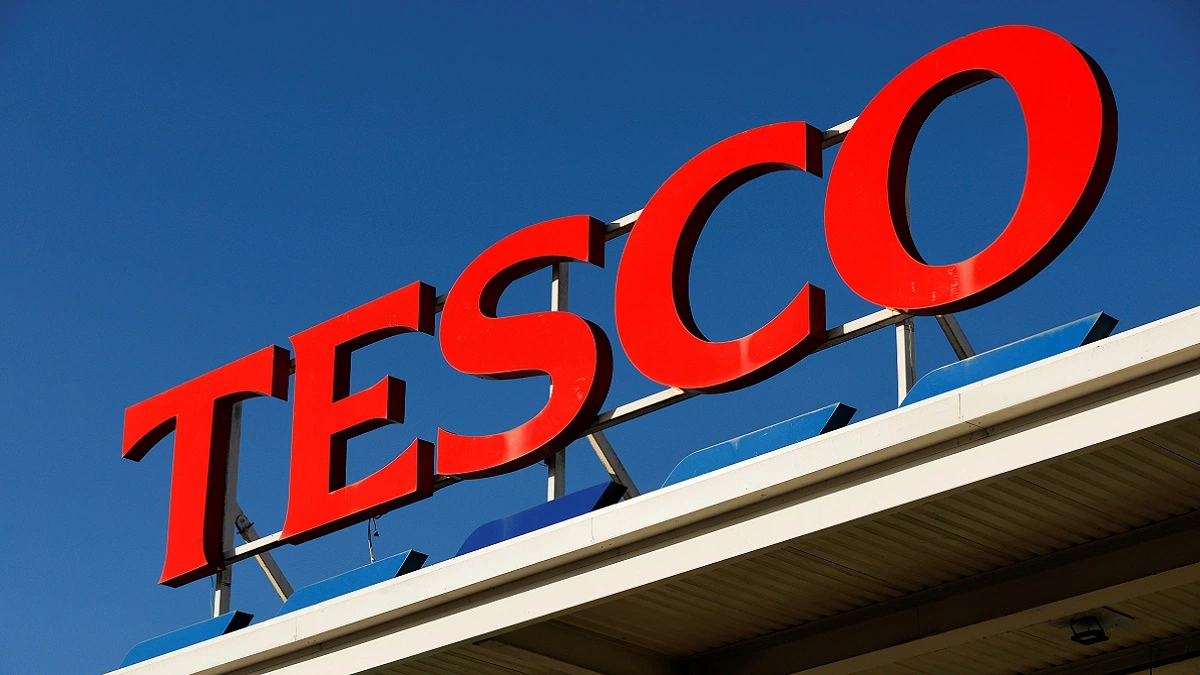 Tesco logo with a clear, blue sky behind it.