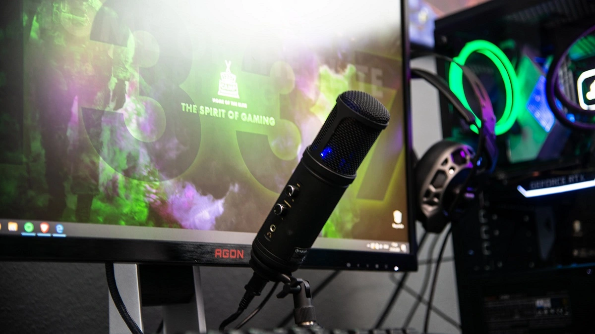 A streaming microphone set up in front of a monitor.