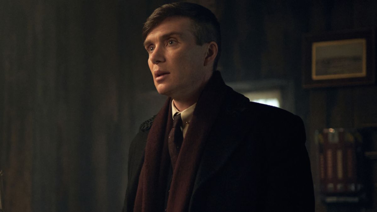 Cillian Murphy standing in a room, looking stunned, in Peaky Blinders.