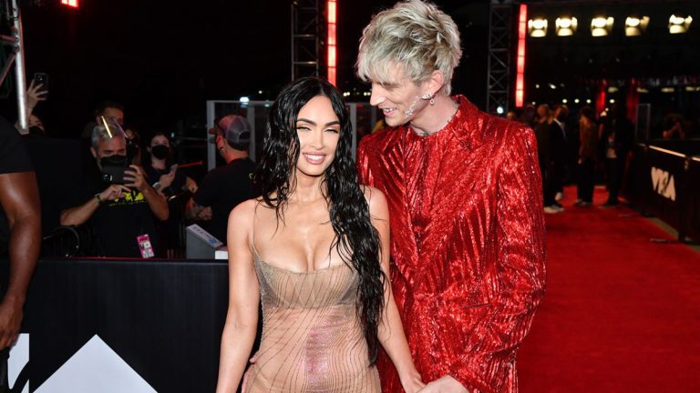 Megan Fox in naked dress at VMAs with Machine Gun Kelly in a red suit.