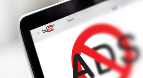 YouTube on a laptop screen with a big "no ads" logo in the middle.