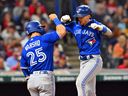 Cavan Biggio, à droite, des Blue Jays de Toronto, célèbre son coup de circuit de deux points avec Daulton Varsho, qui a marqué sur le jeu, lors de la huitième manche contre les Guardians de Cleveland au Progressive Field le lundi 7 août 2023 à Cleveland. 