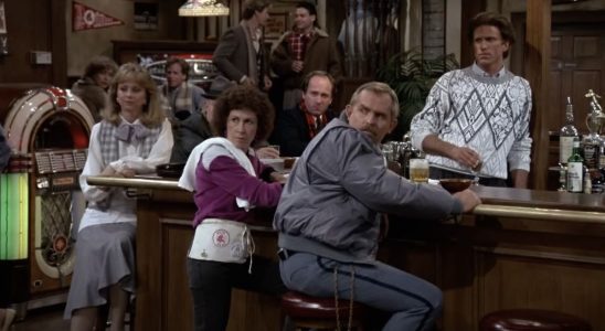 Main cast members from Cheers gathered around bar