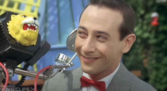 Pee-Wee Herman smiling at his bike in Pee-Wee