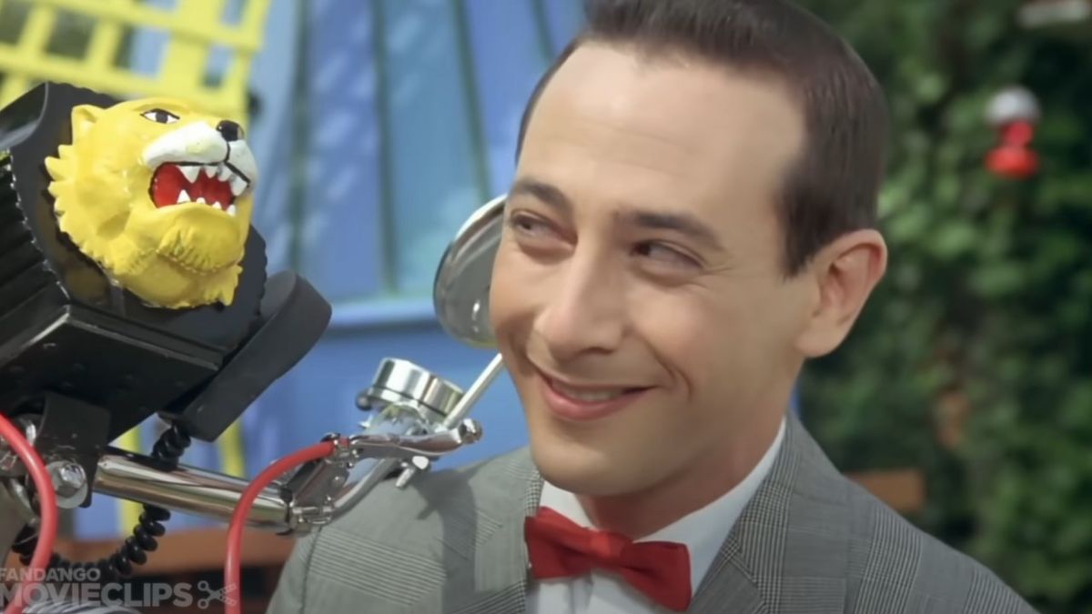 Pee-Wee Herman smiling at his bike in Pee-Wee