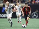 Le milieu de terrain d'Atlanta United Thiago Almada, à droite, passe devant le milieu de terrain du Toronto FC Michael Bradley, à gauche, lors de la seconde moitié d'un match de football de la MLS, le samedi 4 mars 2023, à Atlanta.