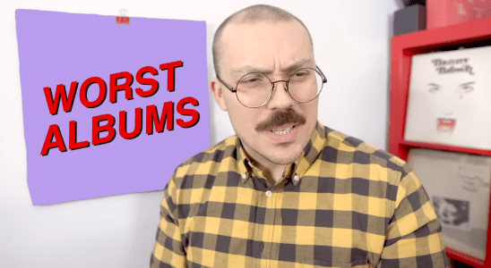 Anthony Fantano looks quizzical in front of a square reading