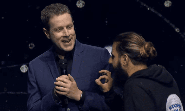 A stagecrasher approaches Geoff Keighley on stage early in Gamescom Opening Night Live 2023.