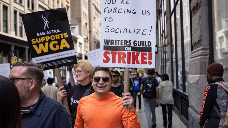 NEW YORK, UNITED STATES - 2023/05/19: Writers Guild of America members march on a picket line in front of Netflix offices. After contract negotiations failed, thousands of unionized writers voted unanimously to strike, bringing television production to a halt, and initiating the first walkout in 15 years. (Photo by Michael Nigro/Pacific Press/LightRocket via Getty Images)